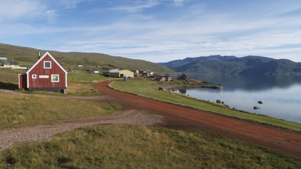 Grusvej og huse langs fjorden i Qassiarsuk